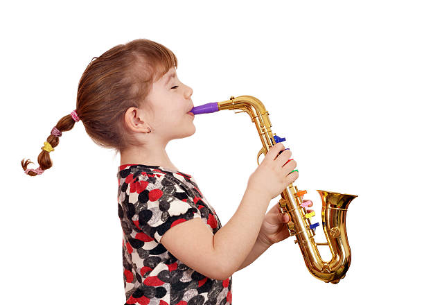 beautiful little girl play music on saxophone stock photo