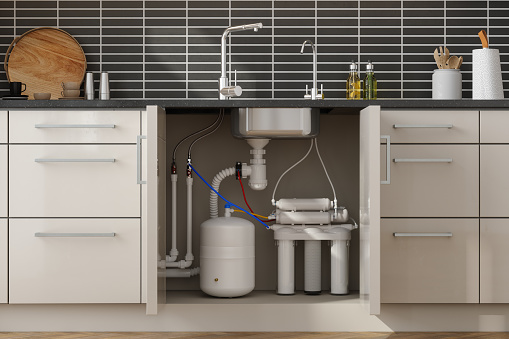 Front View Of Reverse Osmosis Water Filtration System In Kitchen Cabinet