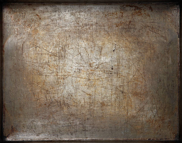 Tray Scratched bottom of an old oven baking tray. baking sheet stock pictures, royalty-free photos & images
