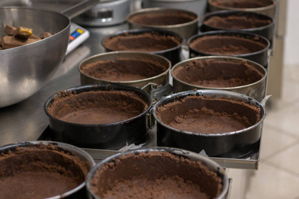istock pastry chef preparing and baking stack of chocolate crust for salty caramel cheesecake 1647851196