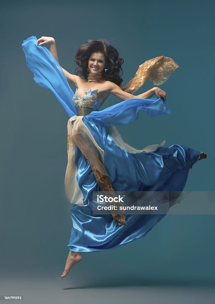 beautiful girl floating in mid-air, blue silk dress Dancer Stock Photo