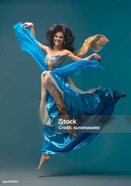 Beautiful Girl Floating In Midair Blue Silk Dress Stock Photo - Download Image Now