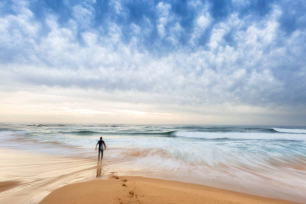 istock Lone Surfer Walking Out to the Ocean 1647922888