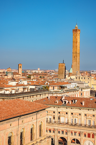 Bologna cityscape with old buildings and famous two towers under the clear blue sky in spring