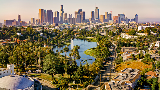 Aerial view of Echo Park Lake surrounded by neighbourhood with high rise office buildings in background, City Of Los Angeles, California, USA.