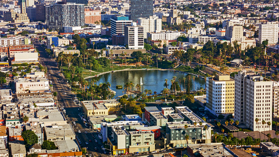 Aerial view of Los Angeles cityscape with residential district surrounding lake with fountain, California, USA.