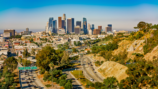 Aerial view of cars driving on street amidst city with buildings, City Of Los Angeles, California, USA.