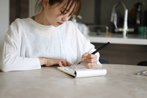 istock A woman writing with a brush pen 1647954477