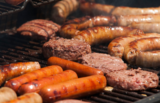 Close-up of a summer barbecue. Grilling hotdogs and hambugers