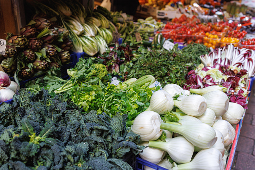 Traditional green and food market stall with fresh vegetables in Bologna, Italy