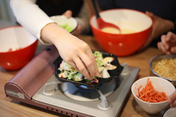 istock woman making takoyaki 1647981310