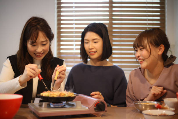 istock woman making takoyaki 1647982144