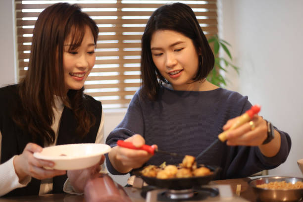 istock woman making takoyaki 1647982992