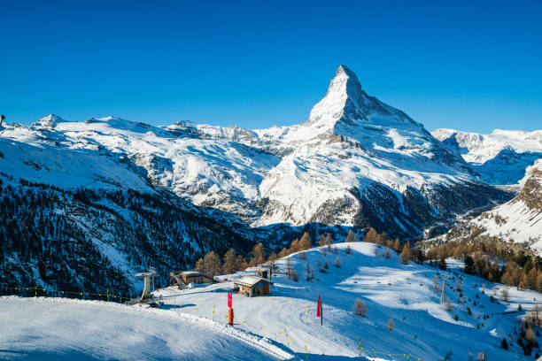 weltweit berühmte berggipfel matterhorn über zermatt stadt der schweiz, im winter - zermatt stock-fotos und bilder