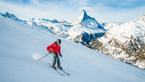 Young skier downhill skiing at Zermatt ski resort, Switzerland stock photo