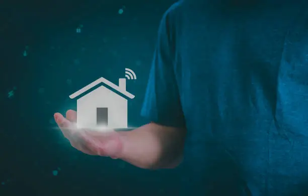 Photo of Man using a smartphone, controlling an intelligent home automation system Futuristic interface on a virtual screen Automation technology of things, concept Data connection with technology internet.