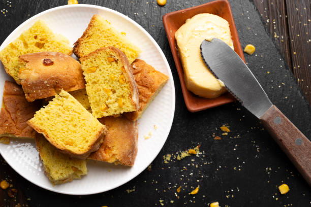istock Homemade cornbread slices on white dish and butter flat lay view 1648008519