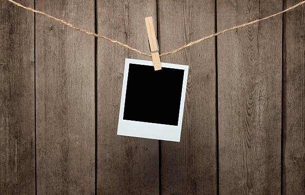 Blank photograph with clipping path Blank photograph hanging clipped to the rope over wooden background with clipping path for the inside of the photo clothespin wood stock pictures, royalty-free photos & images