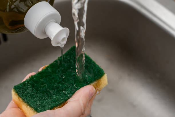 istock Dishwashing liquid applied to a sponge, sink in the background 1648020053