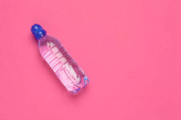 istock Plastic bottles with pure water on pink background top view space for text 1648032044