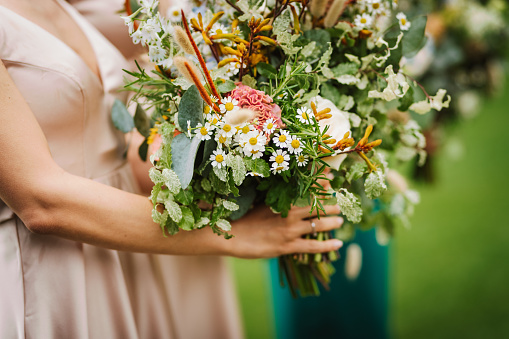 Bridesmaids with flower bouquet.