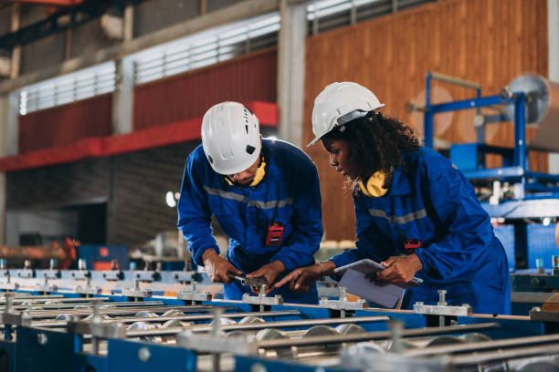 istock Foreman checking Material or Machine. Industrial worker inspecting and check up machine at factory machines.Technician working in metal sheet at industry. 1648057378