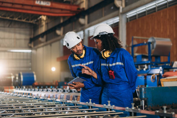istock Foreman checking Material or Machine. Industrial worker inspecting and check up machine at factory machines.Technician working in metal sheet at industry. 1648057964