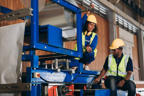 Foreman checking Material or Machine. Industrial worker inspecting and check up machine at factory machines.Technician working in metal sheet at industry.