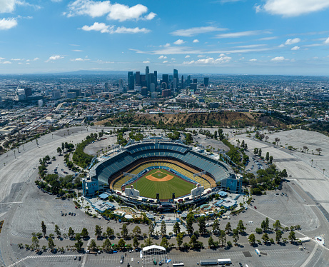 Los Angeles, California, USA - August 23, 2023: Aerial view of Los Angeles Dodger Stadium in Elysian Park, with the skyscraper skyline of Los Angeles in the background. The Stadium is just north of downtown Los Angeles and is the home of the Los Angeles Dodger Major League Baseball team.
