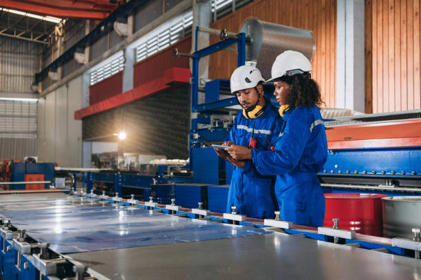 istock Foreman checking Material or Machine. Industrial worker inspecting and check up machine at factory machines.Technician working in metal sheet at industry. 1648060084