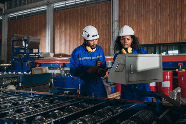 istock Foreman checking Material or Machine. Industrial worker inspecting and check up machine at factory machines.Technician working in metal sheet at industry. 1648060613