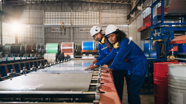 Foreman checking Material or Machine. Industrial worker inspecting and check up machine at factory machines.Technician working in metal sheet at industry.