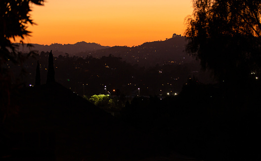 Sunset silhouette of Elysian Park and Griffith Park Observatory in background