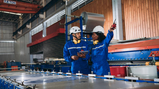 istock Foreman checking Material or Machine. Industrial worker inspecting and check up machine at factory machines.Technician working in metal sheet at industry. 1648062191