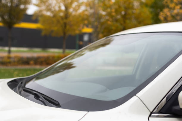 close-up car windshield rain wipers, rainy weather and vehicles concept.
