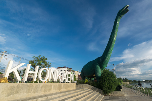 Dinosaur statue the one of Khon Kaen province symbol at Bueng Kaen Nakhon in the evening. Khon Kaen, Thailand.