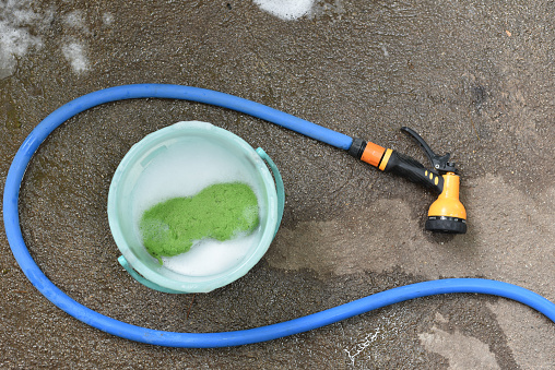 Car wash tool on ground, Water spray with busket and sponge
