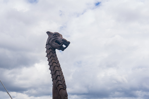 figurehead on the bow of a full-scale replica of a viking ship, against a sky