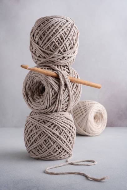 istock Stack of cotton threads pastel color skeins and wooden hook 1648084933
