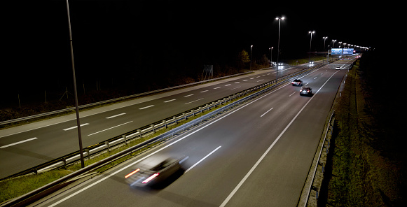 Cars driving on motorway at night.