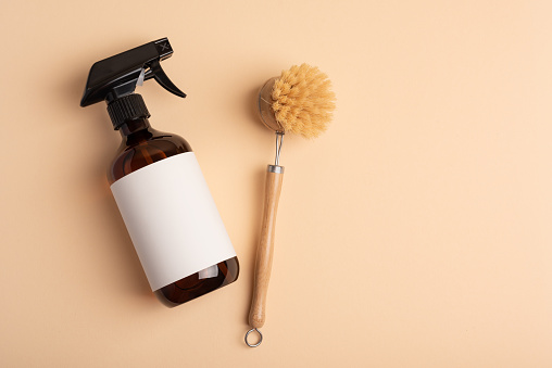 Eco wooden dish brush and spray bottle.  Kitchen cleaning concept for eco-friendly lifestyle.