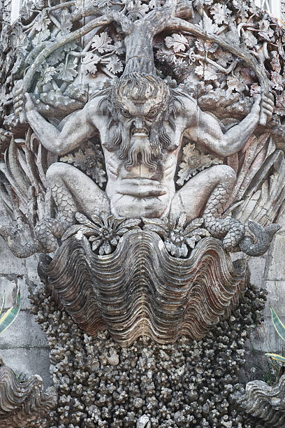 Carved male figure in stone adorning an old building facade