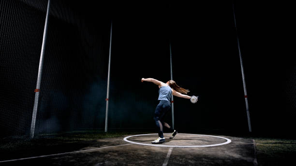 istock Female athlete turning with discus 1648117076
