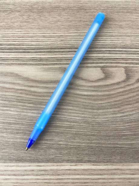 Table top view a ballpoint pen on the wooden desk