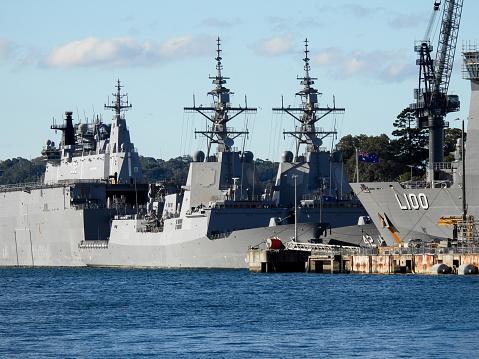 Warships of the Royal Australian Navy docked at Garden Island in Sydney Harbour, from the left: HMAS Adelaide, HMAS Brisbane, HMAS Sydney and HMAS Choules.  This image was taken on a sunny afternoon on 20 May 2023.