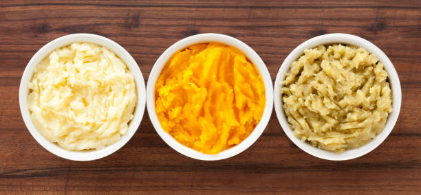 Purees Top view of three bowls containing variety of purees (potato, squash, sweet potato) mashed stock pictures, royalty-free photos & images