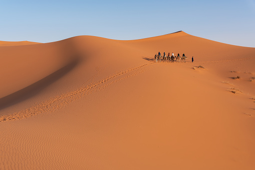 Woman walking playfully in desert sand dunes