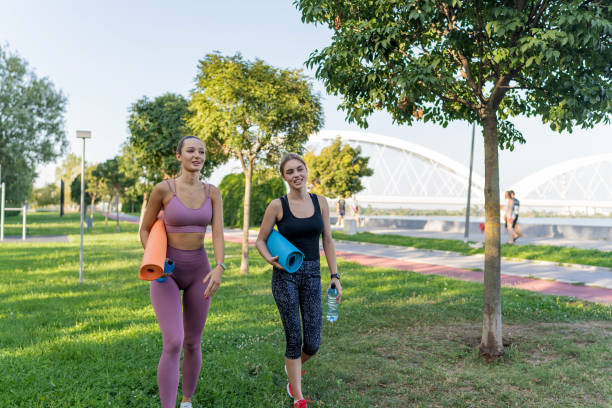 istock Young women with exercise mats on a nature hike 1648158216