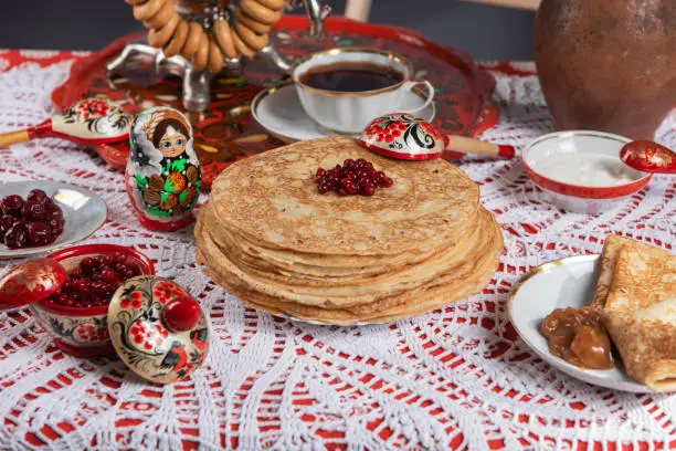 Russian pancake blini with berries and sour cream on the table. Shrovetide Maslenitsa festival concept. Top view. Flat lay