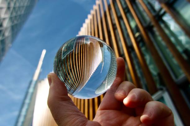 istock Crystal ball against modern buildings 1648167079